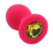 Розовая силиконовая анальная пробка с жёлтым кристаллом - 7 см.