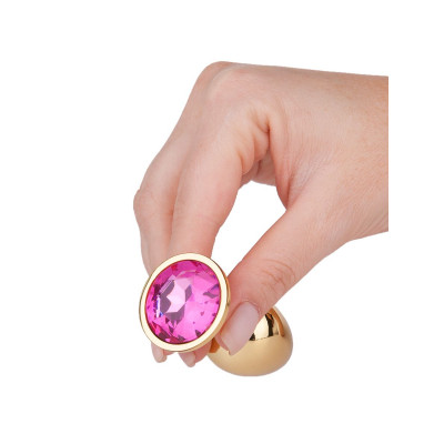 Золотистая анальная втулка с малиновым кристаллом - 7 см. Золотистая анальная втулка с малиновым кристаллом - 7 см.